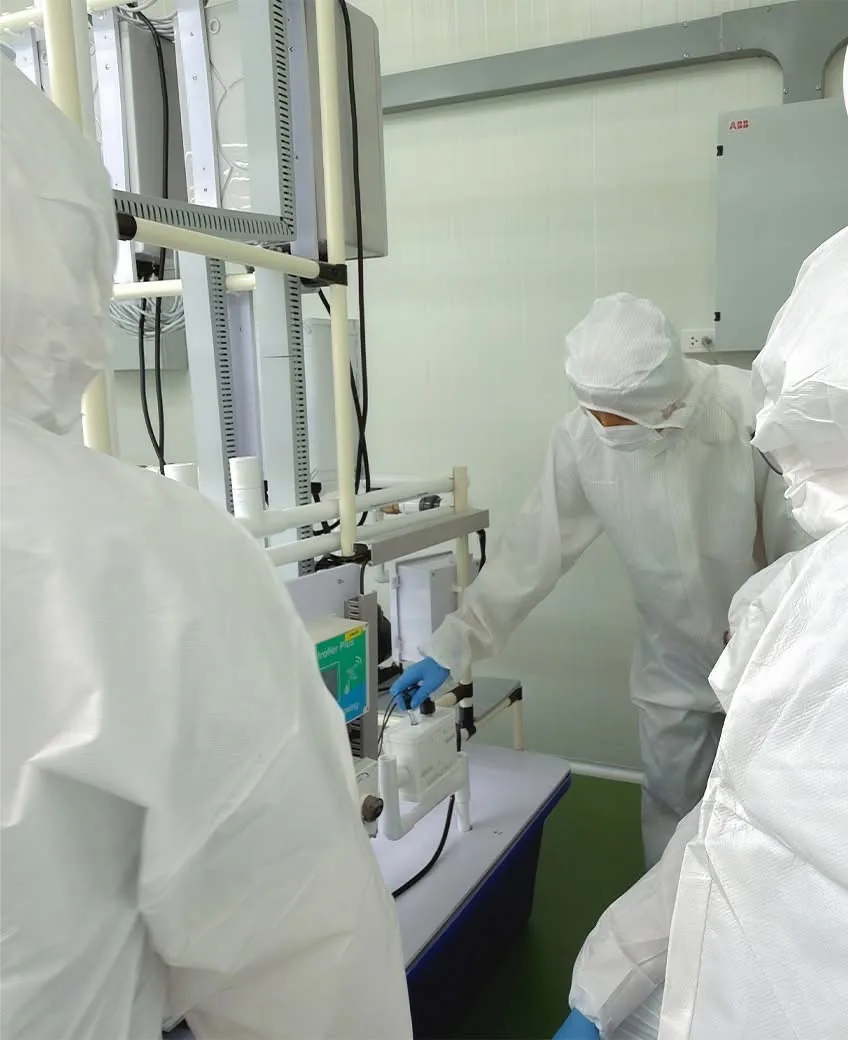 Staff inspecting equipment in a controlled clean production room